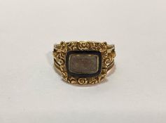 An early 19th century enamel and gold (untested) mourning ring, the glazed compartment containing