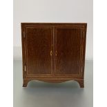 A crossbanded and string-inlaid partridgewood table cabinet, the case with a