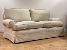 A contemporary upholstered sofa, with squab cushions, moving on castors, retailed by Whytock and