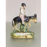 A 19th century Staffordshire figure of Sancho Panza, on a naturalistic base. Height 19.5cm