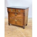 A late 19th century French walnut commode in the Empire taste, the black variegated marble top