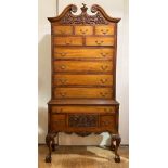 An American "Queen Anne" style walnut highboy, late 20th century, the swan neck pediment over