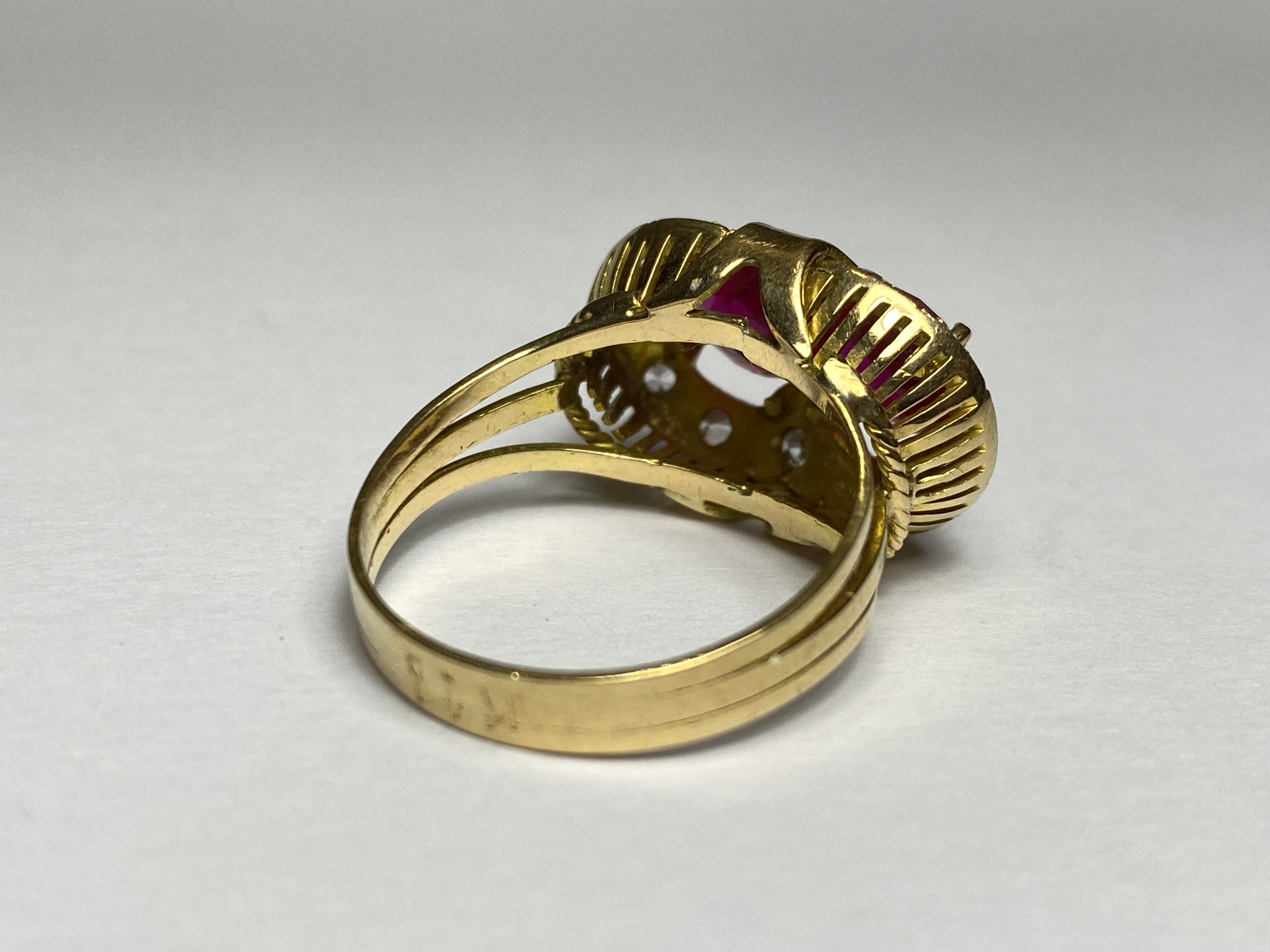 A striking synthetic ruby dress ring, the two round-cut rubies claw-set within a band of round - Image 2 of 2