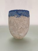 •Clare Conrad (British, b. 1948), a textured stoneware vessel, with a band of blues to the rim,