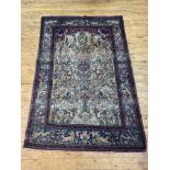 A fine Persian paradise garden rug, hand knotted, the central panel depicting the tree of life on an