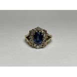 A sapphire and diamond cluster ring, the oval-cut sapphire within a band of ten claw-set old-cut