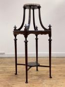 An Edwardian mahogany vase stand, the circular moulded top with gilt brass openwork gallery standing