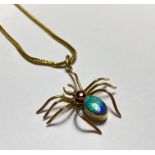 A late 19th century insect pendant, modelled as a spider in yellow metal (indistinctly stamped to