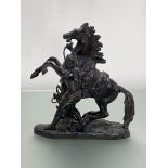 After Coustou, a small patinated bronze model of a Marly Horse, unsigned. Height 19cm