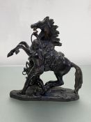 After Coustou, a small patinated bronze model of a Marly Horse, unsigned. Height 19cm