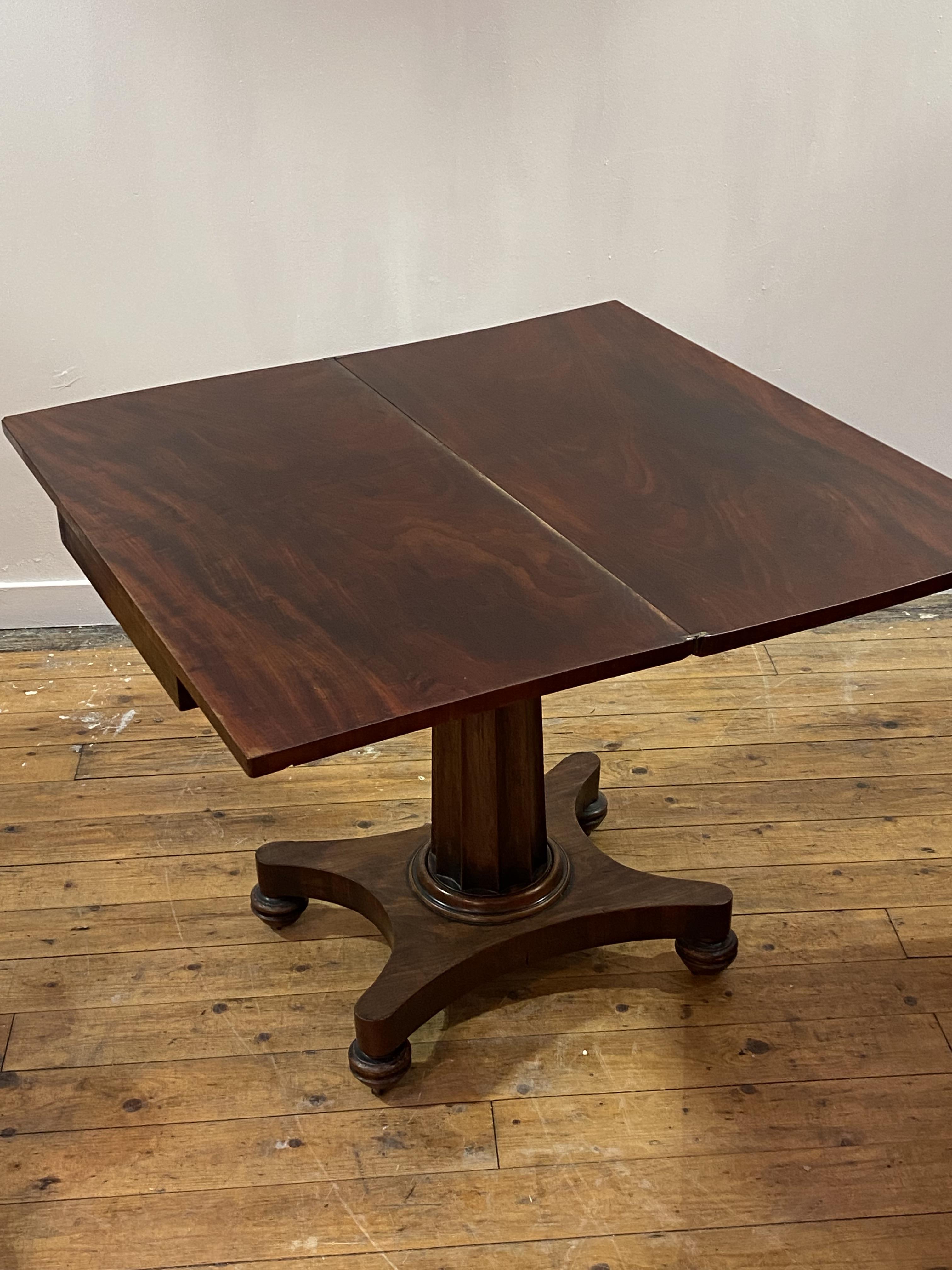 A mid 19th century mahogany supper table, the fold over revolving top over a fluted centre column, - Image 3 of 4