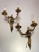 A pair of Louis XV style gilt-metal two light wall appliques cast with foliate scrolls; together