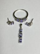 A suite of tanzanite and diamond jewellery comprising: a ring, claw-set with three graduated oval-