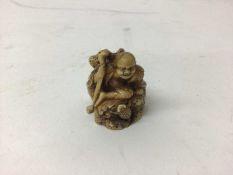 19th century ivory netsuke of a figure on a rock holding a staff with a toad at his feet