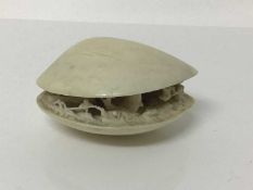 19th century Japanese ivory clam shell diorama, the inside with figures attempting to catch a large