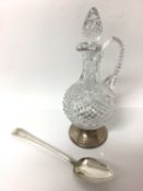 19th century silver basting spoon, together with a silver footed decanter