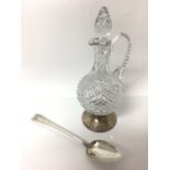 19th century silver basting spoon, together with a silver footed decanter