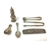 Group of silver, including continental caddy spoon and comb, a teaspoon, two sugar nips, and a caste