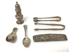 Group of silver, including continental caddy spoon and comb, a teaspoon, two sugar nips, and a caste