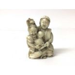 19th century Japanese ivory figure group of a samurai, wife and child, 6.5cm high