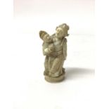 19th century carved ivory group, showing a woman seated on a man's lap, 6.5cm high