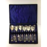 Set of Art Nouveau silver plated dessert cutlery comprising six spoons and six forks with hammered b