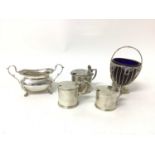 Three silver mustards (two with spoons, one with liner missing), a silver sugar basket with liner, a