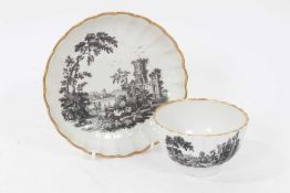 A Worcester fluted tea bowl and saucer, printed with ruins, circa 1770