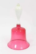 A Victorian cranberry tinted glass bell