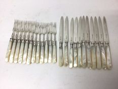 Two near sets of Edwardian silver and mother of pearl cutlery, including twelve knives and twelve fo