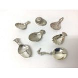 Seven sterling silver caddy spoons, 1916 and later, including jockey cap, seahorse, hand, acorn, etc