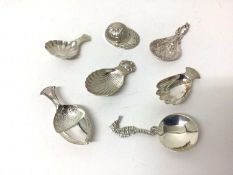 Seven sterling silver caddy spoons, 1916 and later, including jockey cap, seahorse, hand, acorn, etc