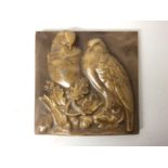 Unusual 1920s ceramic plaque with relief moulded decoration depicting two birds