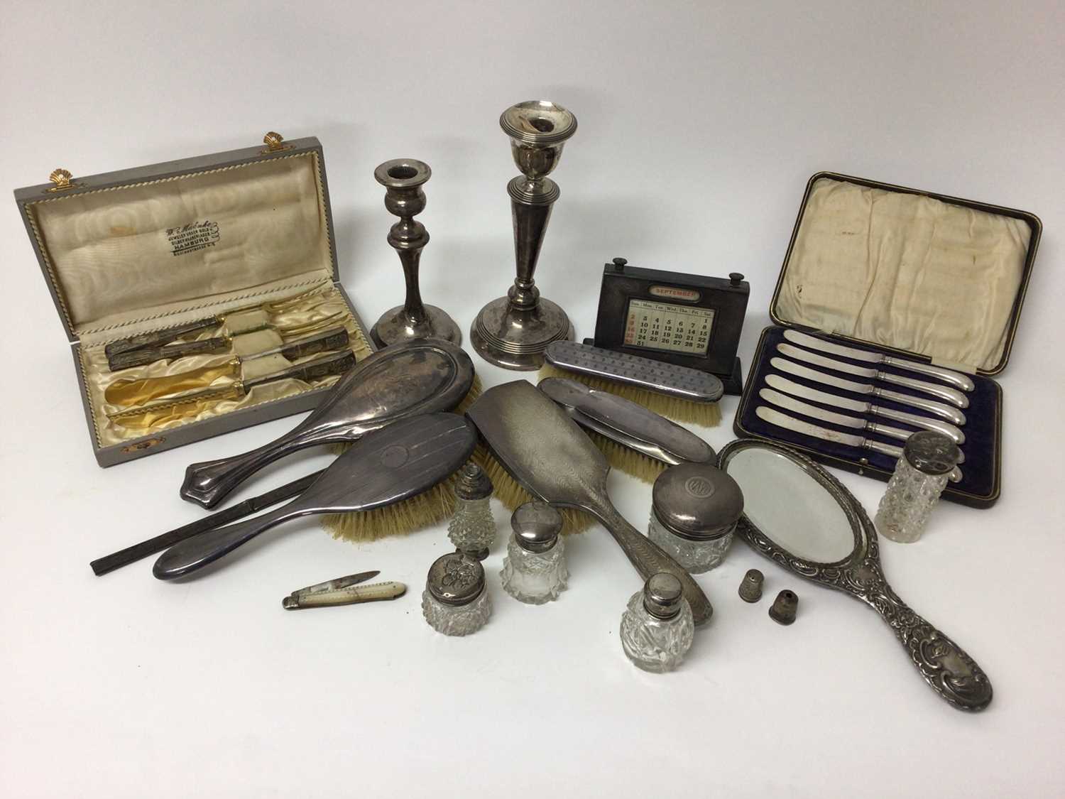 Quantity of silver, including knives, brushes, toiletry jars, desk calendar, etc