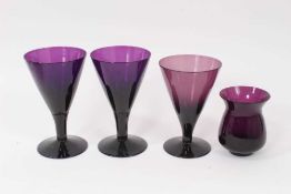 Three 19th century amethyst tinted flared glasses, and a similar tulip shaped cup