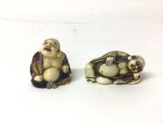 Two 19th century Japanese carved figures of Buddha, one a netsuke and shown reclining, the other pai