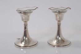 Pair of George V silver dwarf candlesticks with flared central columns on circular bases, (Birmingha