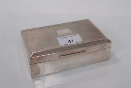 George V silver cigarette box of rectangular form with engine turned decoration to lid with vacant c