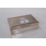 George V silver cigarette box of rectangular form with engine turned decoration to lid with vacant c