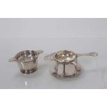 George V silver tea strainer and bowl, (Birmingham 1919), together with another silver tea strainer