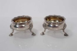 Pair of Victorian silver salts of cauldron form with engraved armorials, gilded interiors and raised