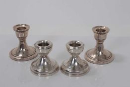 Two pairs of Elizabeth II dwarf silver candlesticks (Birmingham 1958 / 1967), 7 and 5.5cm in height