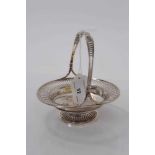 Edwardian silver bonbon dish of circular form with pierced decoration and central swing handle, rais