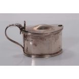 George V silver mustard pot of oval form with receded borders and blue glass liner, (Birmingham 1917
