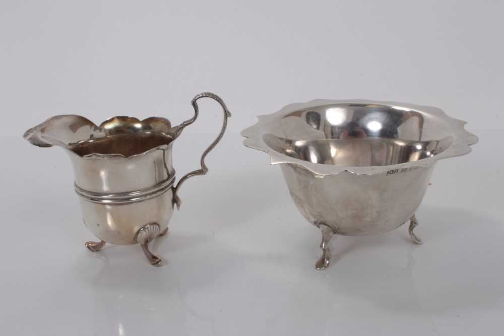 Edwardian silver sugar bowl, raised on three hoof feet, (Birmingham 1902), together with a similar E