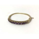 Victorian style gold and amethyst hinged bangle with graduated round mixed cut amethysts and diamond