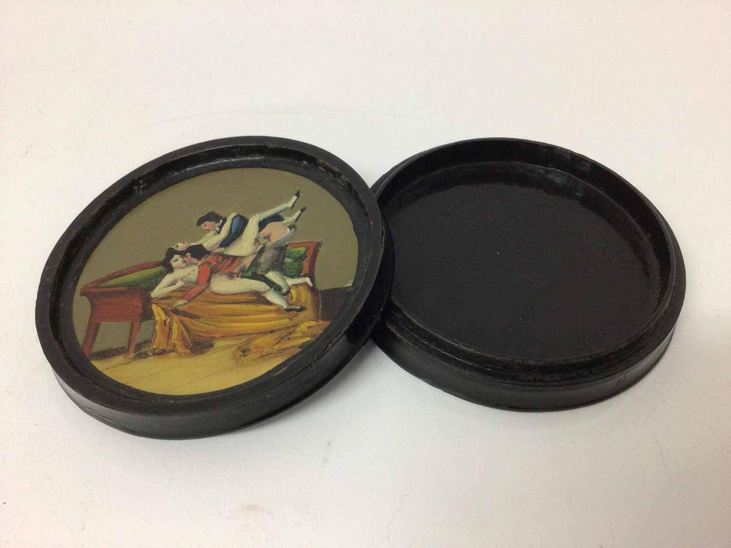 Regency circular papier-mâché erotic table snuff box of circular form with painted dog chasing a duc - Image 2 of 4