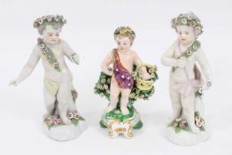 Derby figure of a putto with a basket, circa 1810, and two Derby style figures of putto