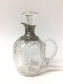 Edwardian silver mounted cut glass claret jug with embossed and pierced silver spout and collar, the