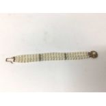 Cultured pearl bracelet with a triple strand of 6mm cultured pearls on a 9ct gold clasp, 18cm.